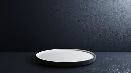 A white plate is on a black table