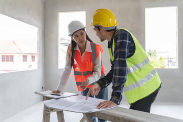 Concept Teamwork of building construction staff. Project engineer contractor reviewing plan of work with foreman and worker at construction site.