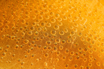 Concept of raindrops falling on yellow background. Abstract wet surface with bubbles on the surface. Realistic drops of clean water