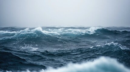 A close-up of rain-swept ocean waves with high winds whipping up the surface, highlighting the chaotic and intense conditions of a storm at sea.
