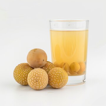 Medium shot of Loganberry juice in a glass near the Loganberry, isolated on a white background 