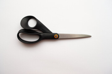 Black handled scissors on a white background.
