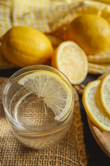Cool freshly made lemonade in glass on wooden table. Space for text