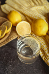 Cool freshly made lemonade in glass on wooden table. Space for text