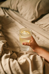 Close up of woman's hand taking a glass of water