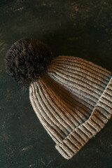Children's warm gray hat on a black background, fashion
