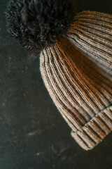 Children's warm gray hat on a black background, fashion