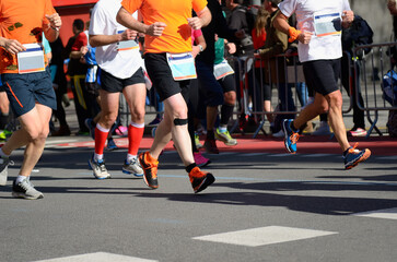 Marathon running race, many runners feet on road racing, sport competition, fitness and healthy lifestyle concept