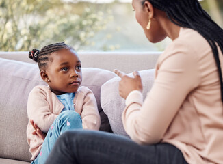 Girl, mother and upset on sofa for discipline, frustrated and check for bad behavior at home. Mom, daughter and discussion in living room for conflict, naughty conduct and punishment with lecture