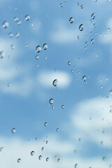 water drop on mirror with blue sky and white cloud background