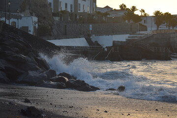 waves in the rocks and houses