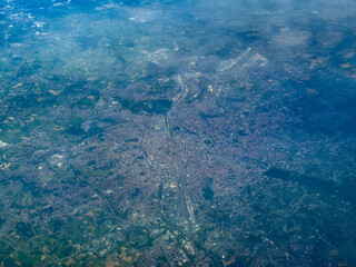 aerial landscape view of Brussels-Capital Region in Belgium, from high level with suburbs, roads, streets, highways and train tracks as well the airport, surrounding the capital of Belgium 
