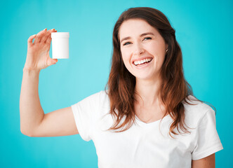 Portrait, woman and health with medicine container, mockup space and logo for brand in studio background. Female person, happiness and promo for pharmaceutical company as wellness coach or influencer