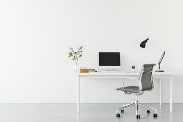 A minimalist office setup featuring a desk, chair, computer, and lamp.