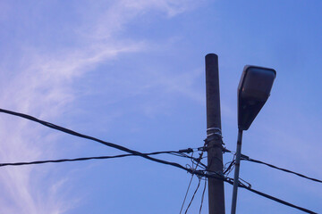 Power electric pole with line wire for residential buildings with blue sky background