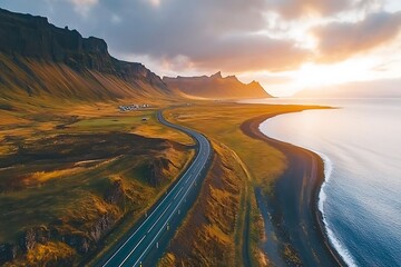 Fototapeta premium Beautiful nature landscape aerial panorama with road, mountains and coast at sunset, sunlight.