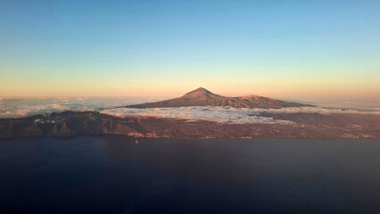 Aerial view of Tenerife island with volcano Teide in the middle with some clouds and beautiful evening light, Canary Islands, Spain