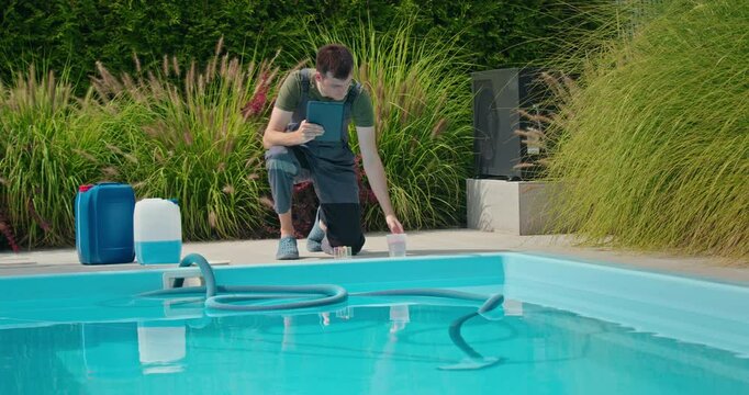 A worker determines the necessary amount of chlorine and pours it into the pool, using a tablet for home pool maintenance.