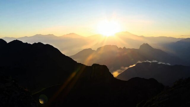Timelapse of a Glorious Sunrise Emerging from Behind the Majestic Mountains