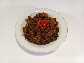 Yummy minced black pepper beef, tender and flavorful, served in a white bowl against a pristine white background. A savory dish, perfect for enjoying with rice or noodles