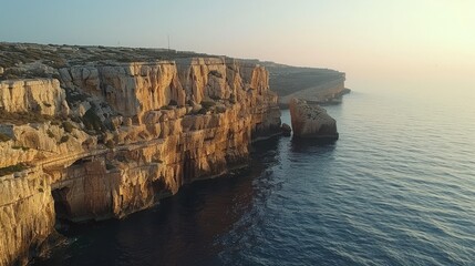 An aerial view of the Dingli Cliffs emphasizes their steep, jagged rock faces and dramatic drop,...