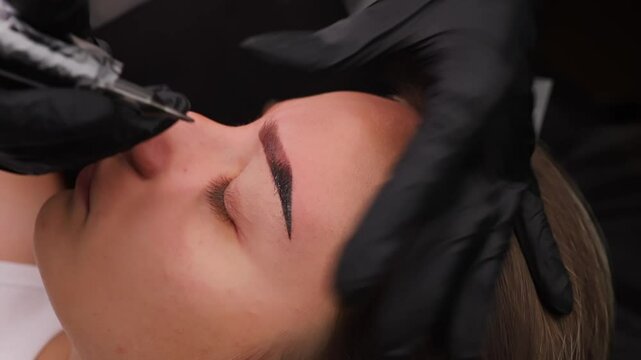 A procedure to fill pigment into the eyebrow using a tattooing technique. Light permanent eyebrow makeup, performing eyebrow tattooing