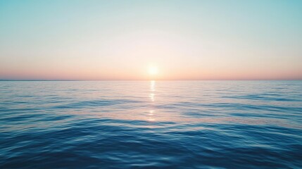 Fototapeta premium A calm sea with the sun setting in the distance, creating a perfect space for text. No people.
