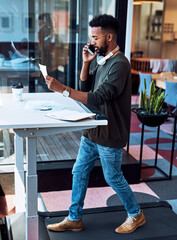 Paperwork, walking and businessman on office treadmill for cardio exercise, legs workout or mobility. Steps, active fitness or healthy designer on standing desk in breakroom for phone call or deal