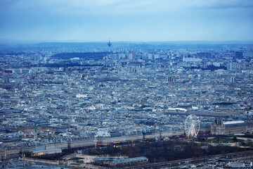 Naklejka premium Dusk cityscape of Paris with Ferris wheel near Louvre in winter