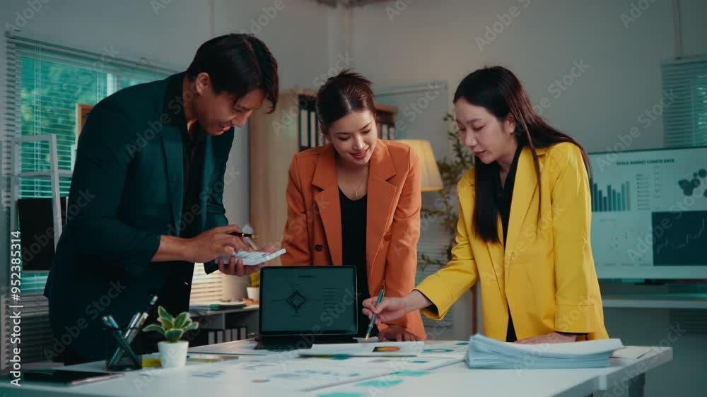 Poster Team members engage in a discussion about financial data while collaborating in an office setting. Their focus on analysis and strategy highlights effective teamwork and communication