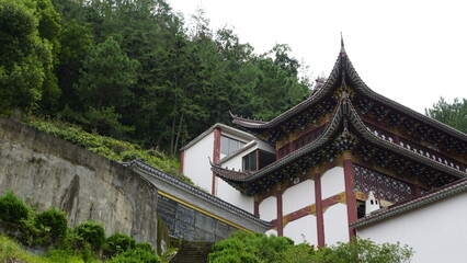 Chinese Pagoda temple with traditional pointed roof surrounded by nature in China, tradicional buddhist ancient architecture