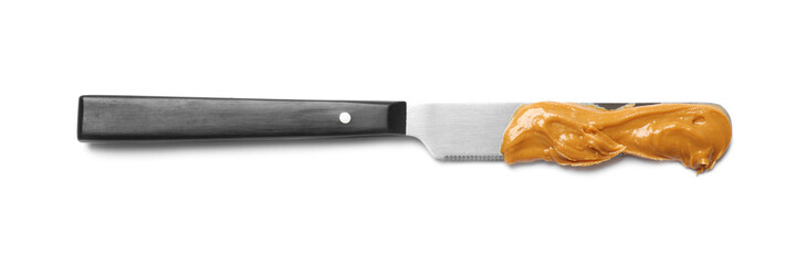 Knife with tasty peanut butter isolated on white, top view
