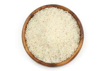 Raw white rice on wooden background. Long uncooked rice in wooden plate. Natural organic food. Traditional Asian cereal culture.