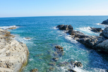 The waves of the raging sea wash over the cliffs