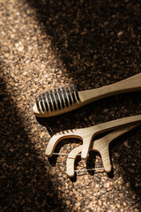 Bamboo Toothbrushes and Floss Picks on Cork Surface