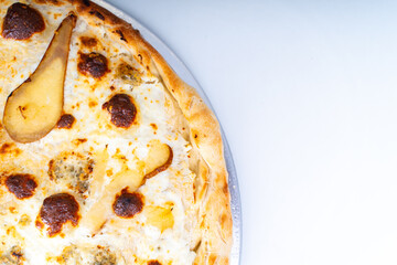Cheese pizza with pear close-up. Background