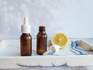 Amber Glass bottle with vitamin C . Vitamin C serum with lemon  fruit