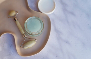 Anti-Aging Aloe Cream and jade roller in a marble tray 