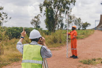 Surveyor engineer worker making measuring with theodolite tool equipment at construction site....