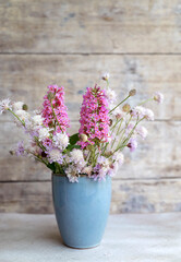 Small blue vase with beautiful summer flowers 