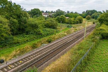 Obraz premium Aerial drone shot of rail tracks in the middle of a rural area in UK