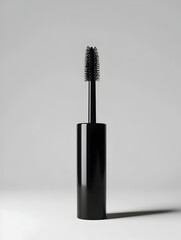 Closeup Black Matte Mascara Tube with Elegant Cursive Label on Isolated White Background