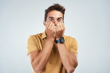 Man, scared and nervous in studio portrait, anxiety and suspense for announcement on white...