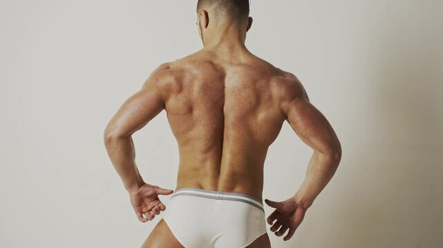 Back of Sexy muscular shirtless man with perfect fit shoulders, and chest. Sexy male muscular body. Man with sexy naked torso. Muscular topless male sexy model, sports athlete with muscle.