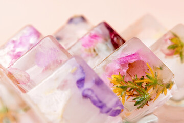 Ice pyramids with fresh frozen blossom flowers inside it with colorful petals