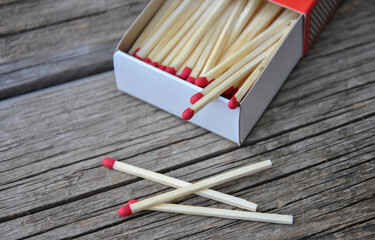 open matchbox and matches on wooden table close-up. selective focus