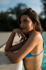 hot brunette with blue bikini at pool