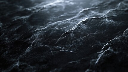 Close up shot of dark grey rough textured rock surface with a white vein running through it.