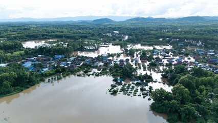 defaultThe aerial photograph shows the severe flooding in Nan Province on August 22, 2024. The image reveals entire residential areas submerged under murky floodwaters.