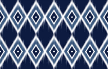 Navy and white ikat-inspired pattern. Blurred diamond shapes create geometric pattern. Traditional weaving pattern reimagined. Suitable for fabric, wallpaper, and digital designs. Seamless ethnic.